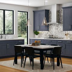 a large kitchen with blue cabinets and white counter tops, along with a dining table surrounded by black chairs