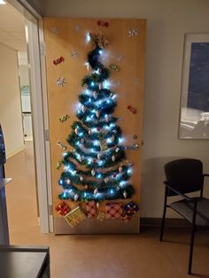 a decorated christmas tree in front of a door