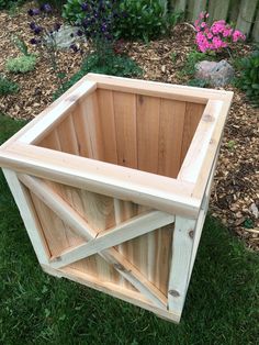 a wooden box sitting in the grass