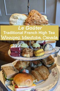 three tiered tray with sandwiches and cakes on it that says le gouter traditional french high tea whinege mantoba, canada