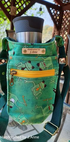 a green purse with a cup in it