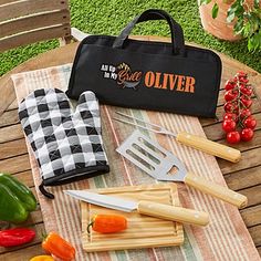 an outdoor picnic table with utensils and vegetables