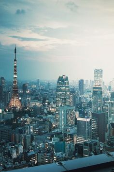 the cityscape is lit up at night with skyscrapers in the background,