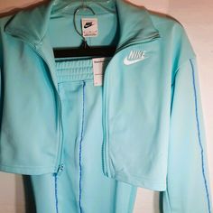 This Darling Set Consists Of A Long Sleeve Front Zip Jacket And Long Matching Pants. The Cuffs On The Jacket And Pants Are Ribbed. The Color Is Aqua Blue With Contrasting Blue And White Piping. The Nike Logo Is Embroidered In White On Both The Jacket And Pants. There Are Two Pockets On The Pants. These Sets Are Nwt And Were Sourced At An Authorized Nike Outlet. The Size Girls Medium (Standard Fit). The Jacket Measures 16 Inches From Collar To Bottom Hem. The Jacket Measures 18" From Shoulder Sea Boys Nike Outfits, Nike Sweatsuit, Jacket And Pants Set, American Flag Shorts, Nike Outlet, Jogging Suit, Hoodie And Sweatpants, Nikes Girl, Track Suit