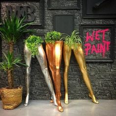 three metal planters sitting next to each other