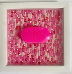 a pink object in a white frame