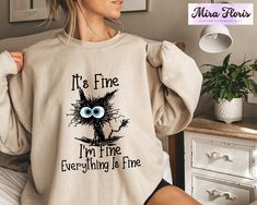 It's Fine I'm Fine Everything is Fine Sweatshirt, Introvert Sweatshirt, Sarcastic Sweat, I'm Fine, Everything is Fine T-Shirt, Mental Shirt Unisex Sizing Across All Products Discover your perfect fit with our size and color guides, available in the product photo gallery. How to Order from Our Etsy Store Excited about our offerings? Follow these easy steps to make them yours: 1. Explore: Browse our curated collection and find products that resonate with your style. Our attention to detail shines through in every piece. 2. Select: Found something you love? Click on it for more details like size, color, and personalization options. 3. Customize: Pick your preferences from the dropdown menus. For personal touches, use the provided text box for your specifications. 4. Add to Cart: Once you're s Cat Grumpy, Funny Animal Shirts, Sarcasm Shirts, Cozy Cat, Ew People, Cute Black Cat, Cat Mom Gifts, Cat Lover Shirt, Lazy Cat