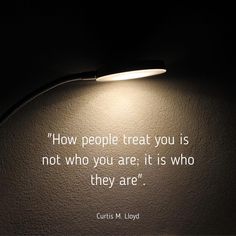 a light shines brightly on a wall with a quote from curtis m lloyd about people treat you is not who you are, it is who they are