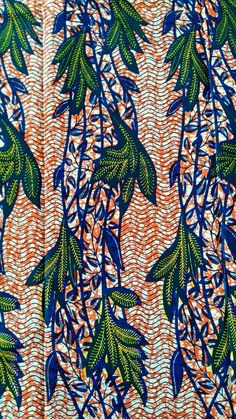 an orange and blue fabric with green leaves on it