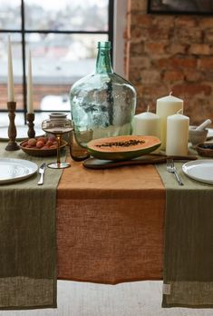 the table is set with watermelon slices and candles