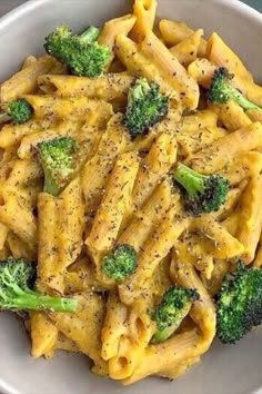 a white bowl filled with pasta and broccoli