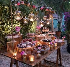 a table topped with lots of cakes and desserts