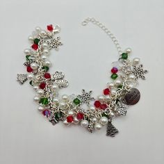 This beautiful charm bracelet will put you in the Christmas spirit!  Perfect gift giving idea!  This bracelet is made up of antique silver nickel free charms, faceted red, green, crystal and pearl glass beads.  Lobster clasp with extender chain for just the right fit. Xmas Bracelets, Christmas Chain, Bracket Ideas, Christmas Charms, Green Crystal, Christmas Jewelry, Christmas Spirit, Handmade Christmas, Charm Bracelets