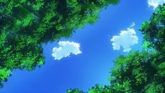 the sky is blue and green with clouds in between some tall trees on either side