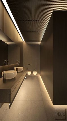 an image of a bathroom with lights on the ceiling and two sinks in the middle