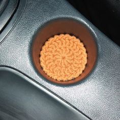 a close up of a steering wheel with a crochet doily in the center