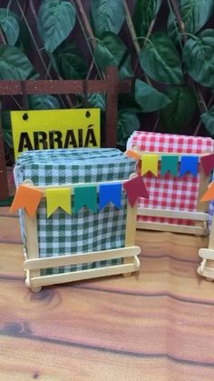 three small baskets with flags on them sitting on a table next to a sign that says arriaia