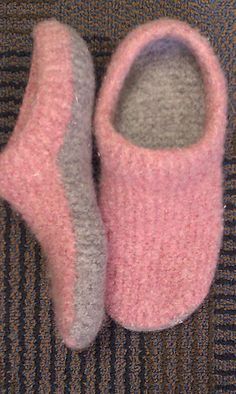 two pairs of pink and grey slippers on carpet