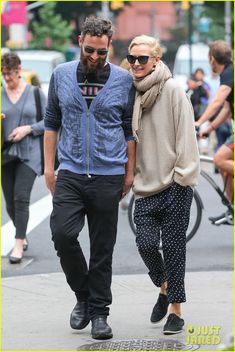 a man and woman walking down the street