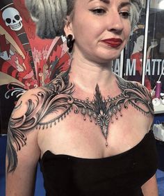 a woman with grey hair and tattoos on her chest