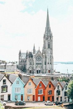 colorful houses line the street in front of a cathedral