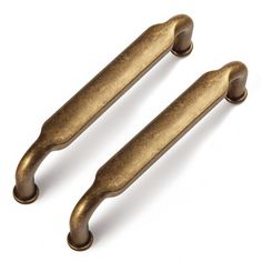 two antique brass cabinet pulls on a white background