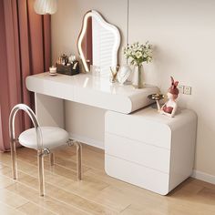 a white dressing table with a mirror and stool next to it on a hard wood floor