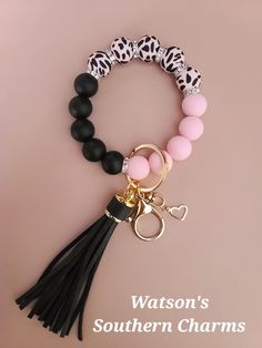 This STRETCHY Pink Cow Wristlet Keychain with Black & Pink silicone beads makes a great gift or just keep it for yourself!  These are hand made using 100% Food Grade Silicone Beads (Non-Toxic). You will receive 1 Wristlet keychain exactly like the picture. Each Wristlet Keychain comes with a total of 15 beads, but I am happy to add 1 extra bead if needed, at no additional cost. These are hand made using 100% Food Grade Silicone Beads (Non-Toxic). These are made with elastic cord so they will eas Silicone Bead Ideas, Wristlet Ideas, Silicone Keychain, Southern Charms, Pink Cow, Wristlet Keychain, Silicone Beads, Beads Jewelry, Food Grade Silicone