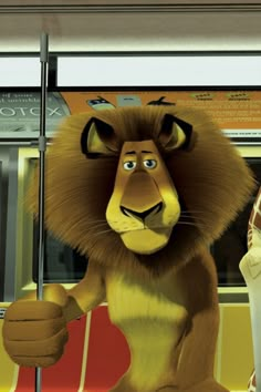 the lion and the mouse are standing next to each other in front of a bus