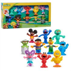 an assortment of sesame street toys in a box