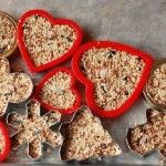 six heart shaped cookie cutters are on a baking sheet with some oatmeal in them