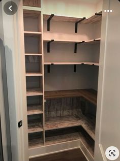 an empty walk in closet is shown with shelves and shelvings on the walls