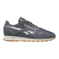 Reebok Men's CLASSIC LEATHER fashion sneakers feature a leather upper. Lace closure. EVA midsole. Textile lining. Rubber outsole. Grey - Gold - Chalk men fashion sneakers athleisture throwback casual tennis shoes retro Size: 10.  Color: Gray.  Gender: male.  Age Group: adult. Casual Tennis Shoes, Reebok Classic Leather, Shoes Retro, Reebok Classic, Sneakers Men Fashion, Grey And Gold, Classic Leather, Fashion Sneakers, Lace Closure