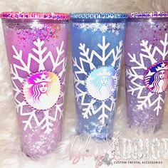 three starbucks cups decorated with snowflakes and glitter