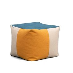 an orange and blue pillow sitting on top of a white floor