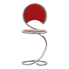 a red chair sitting on top of a metal stand