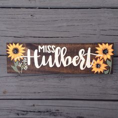 a wooden sign that says miss tulbett with sunflowers on it and the word