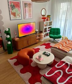 a living room filled with furniture and a flat screen tv on top of a wooden stand