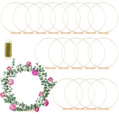 a wreath with pink roses and green leaves is surrounded by several different sizes of rings