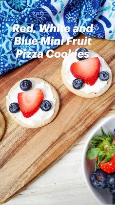 three cookies with strawberries and blueberries on them