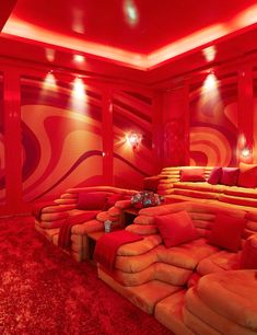 an orange and red room with lots of couches