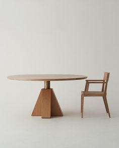 a wooden table and chair sitting next to each other