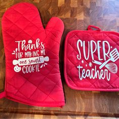 two oven mitts that say thanks for making me super teacher and one small cookie