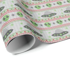 an ugly christmas wrapping paper with aliens and snowflakes on the bottom, in white