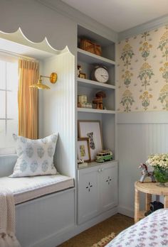 a bedroom with a window seat and wall paper