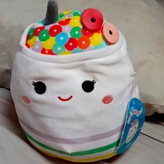 a stuffed toy with buttons on it's head and in the shape of a bag