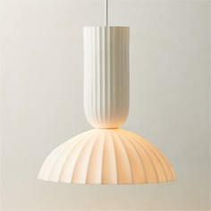 a white lamp hanging from a ceiling in a room