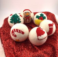 six christmas ornaments are sitting on a red cloth