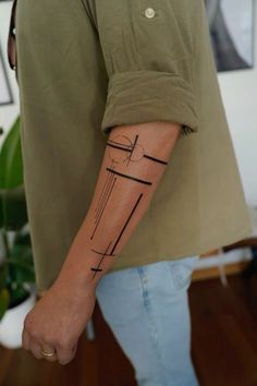 a person with a cross tattoo on their arm