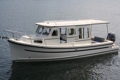 a white boat floating on top of a body of water